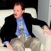 Michael Claxton wearing his tie imprinted with hundreds of photos of Dell O Dell